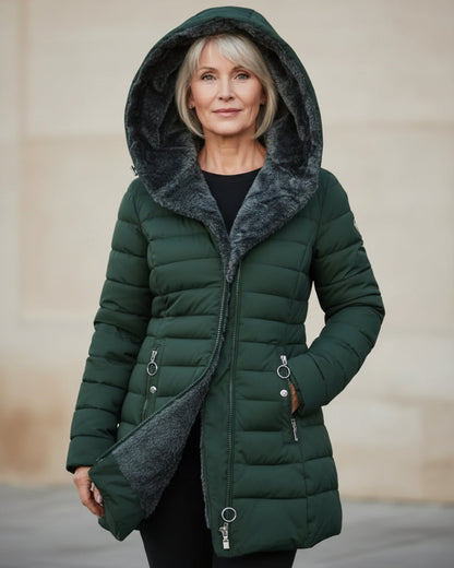 Woman wearing a green puffer coat with a hood. Winter fashion style.