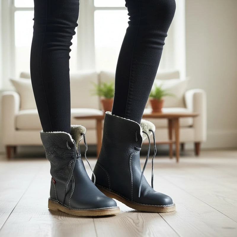 Person wearing blue boots with fur trim indoors