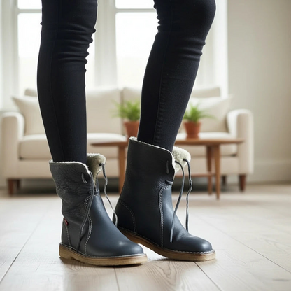 Person wearing blue boots with fur trim indoors